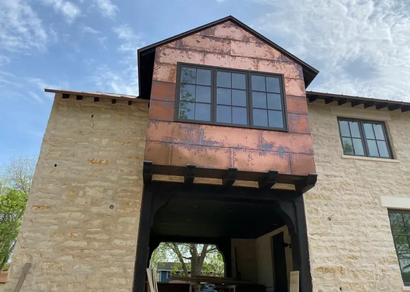 Copper metal panel facade on a stone building for Metal Roof Coating in Ankeny